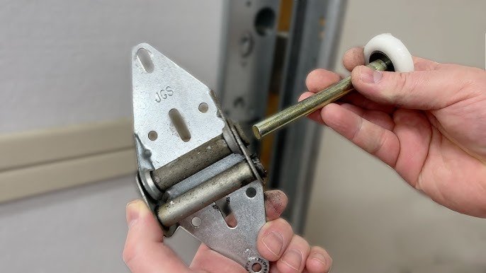 Technician replacing worn-out hinges on a garage door.