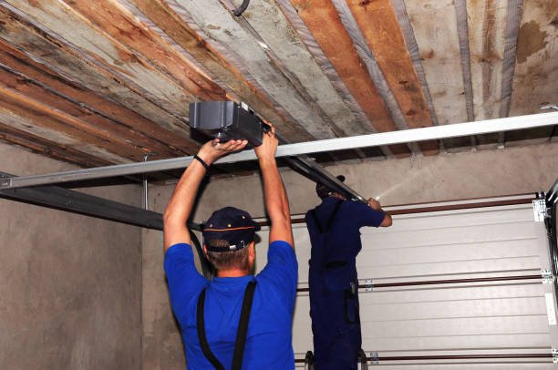 Close-up of a technician connecting a chain-driven garage door opener.