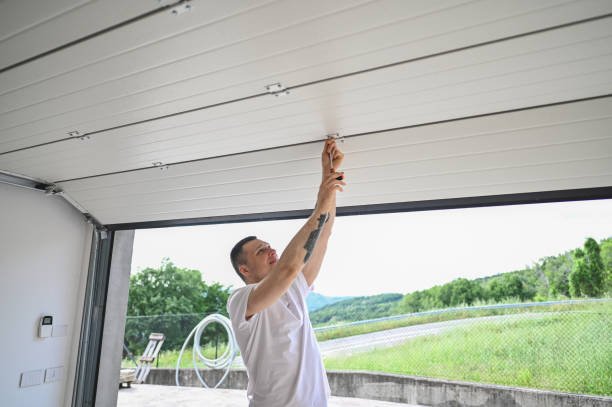 Close-up of a technician fixing a malfunctioning garage door opener.