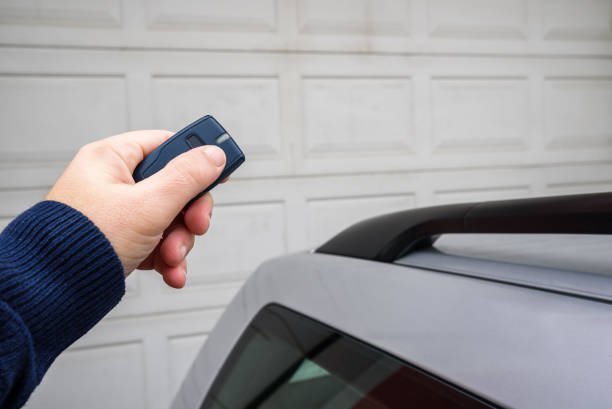 Hands installing a wired garage door keypad to ensure secure entry.