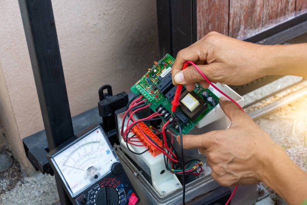 Technician installing a wireless keypad for garage door access.