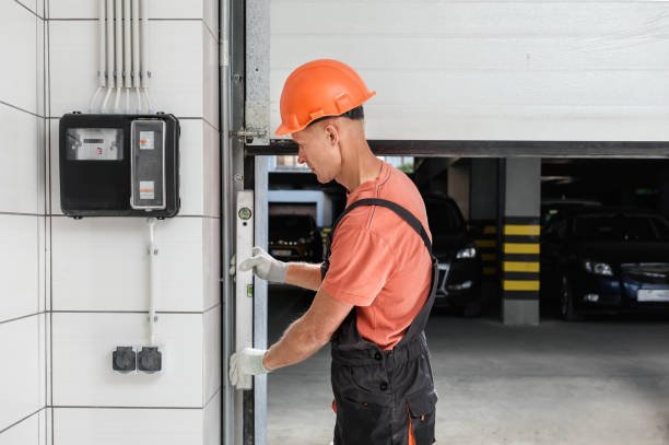 Technician replacing a damaged garage door panel to restore its appearance.