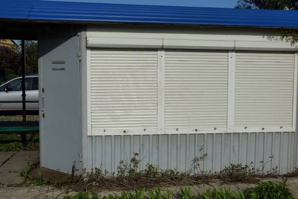 Technician applying weather stripping to the bottom of a garage door.