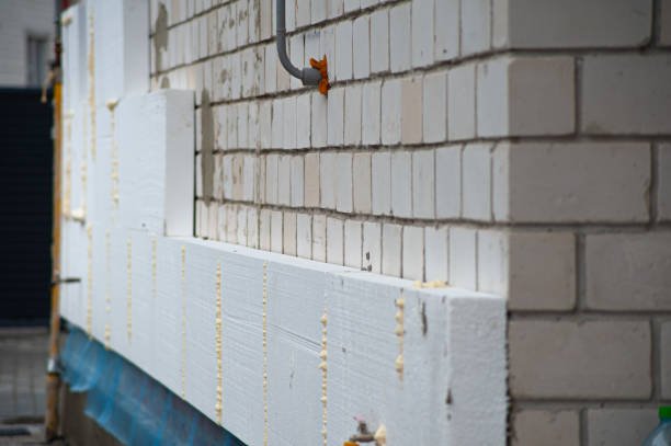 Close-up of weather stripping being installed along the sides of a garage door.